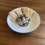 Goat cheese ball coated in cranberries, green onion, and pecans