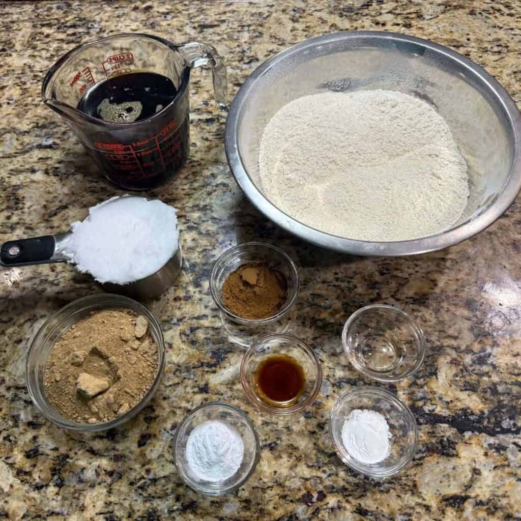 Ingredients to make a pumpkin cake set out on counter in bowls.