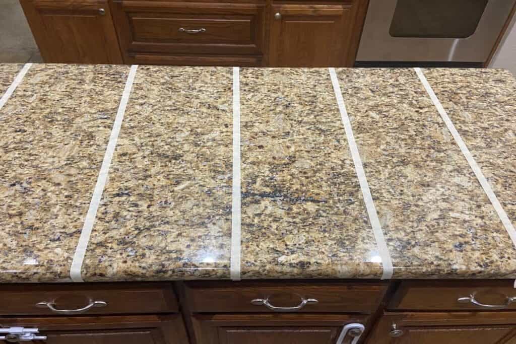 Kitchen counter sectioned off to test natural cleaners against store-bought.